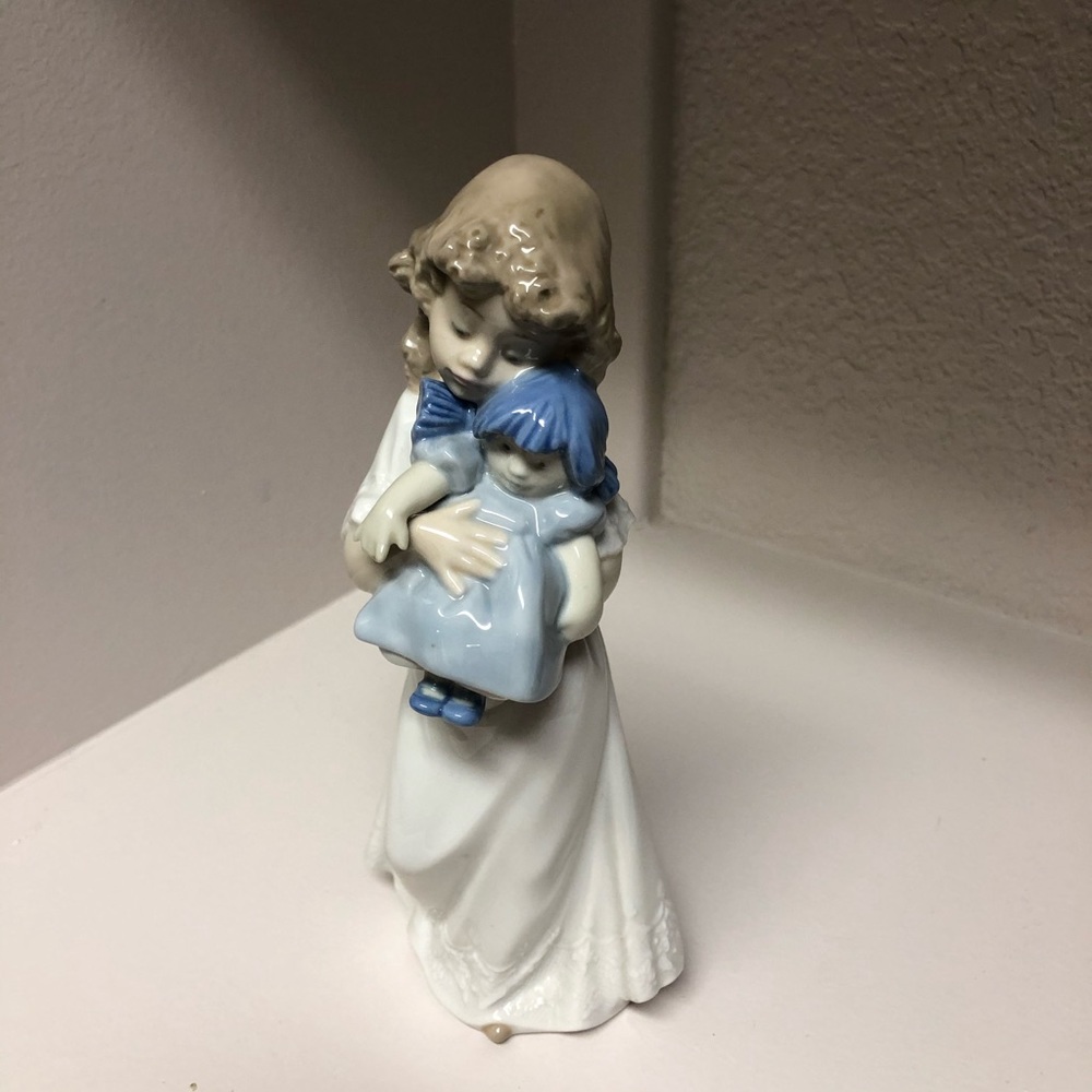 Girl with doll figurine